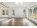 Bright living room with hardwood floors, neutral paint, modern lighting, and large windows at 400 Stone Lea Trce, Oxford, GA 30054