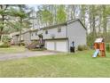 This charming two-story home has a large lawn and a swing set and slide set for entertainment at 175 W Station Nw Dr, Kennesaw, GA 30144