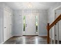 Inviting foyer with a decorative front door, beautiful flooring, and a classic chandelier at 3019 Havenwood Way, Stonecrest, GA 30038