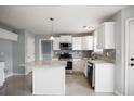 Modern kitchen featuring white cabinets, granite countertops, and stainless steel appliances at 3019 Havenwood Way, Stonecrest, GA 30038