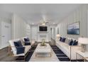 Stylishly decorated living room with a white brick fireplace, plush seating, and modern decor at 3983 E Hilda Cir, Decatur, GA 30035