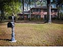 Brick home showcasing a well-maintained lawn and charming mailbox at 746 Oak Terrace Ter, Norcross, GA 30071