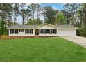 Charming single story home with a sprawling front lawn and a two car garage at 756 Butler Ct, Lawrenceville, GA 30044