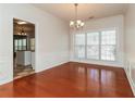 Bright dining room with hardwood floors and a large window providing natural light at 2168 Sugar Maple Nw Cv, Acworth, GA 30101