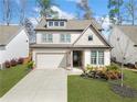 Beautiful two-story home showcasing a manicured front yard and a charming facade with a covered entryway at 234 Fieldbrook Xing, Canton, GA 30115