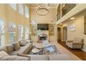 Open-concept living room featuring built-in shelving, fireplace, and modern light fixture at 2369 Apalachee Crucis Ln, Dacula, GA 30019