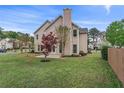 Spacious backyard with a grassy area, trees, and a partial view of the home's exterior at 2500 Grand Manor Ct, Marietta, GA 30068