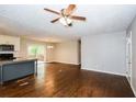 Open-concept living room with hardwood floors seamlessly connects to the kitchen area at 3773 Sarahs Ln, Tucker, GA 30084