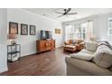 Bright living room featuring a ceiling fan, hardwood floors, a sofa, and comfortable leather chair at 1732 Liberty Nw Pkwy, Atlanta, GA 30318