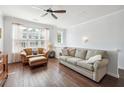 Comfortable living room featuring hardwood floors, natural light, and modern ceiling fan at 1732 Liberty Nw Pkwy, Atlanta, GA 30318