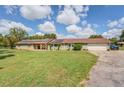 Inviting single-story home featuring a well-maintained lawn, long driveway, and a spacious two-car attached garage at 3557 Bill Gardner Pkwy, Locust Grove, GA 30248