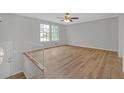 Bright and airy living room featuring hardwood floors, a ceiling fan, and large windows with natural light at 149 Roy Huie Rd, Riverdale, GA 30274