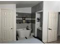 Spa-like bathroom with a modern tub, vanity, and stylish tile accents at 1506 Ravenel Rd, Conley, GA 30288