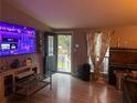 Inviting living room with Roku TV, wood-look floors, and an open doorway at 1506 Ravenel Rd, Conley, GA 30288