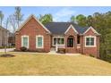 Beautiful, single-story brick home with manicured lawn and inviting entrance at 4457 Equity Ct, Ellenwood, GA 30294