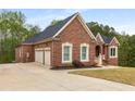 Lovely brick home with a two-car garage and a pristine, well-maintained lawn at 4457 Equity Ct, Ellenwood, GA 30294
