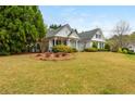 Inviting home exterior surrounded by lush greenery and a neatly maintained lawn at 133 Newcastle Walk, Woodstock, GA 30188