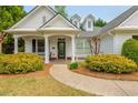 A welcoming front porch with a charming walkway and colorful landscaping at 133 Newcastle Walk, Woodstock, GA 30188