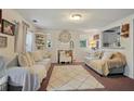 Bright living room with neutral tones, a decorative fireplace, and an open view to the kitchen enhances a cozy atmosphere at 3750 Mckown Rd, Douglasville, GA 30134