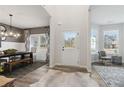 Bright entryway featuring wood floors, a stylish rug, and views into the dining and living areas at 415 Rodeo Dr, Auburn, GA 30102