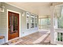 Welcoming front porch featuring a wood deck and a stained glass front door at 7746 Tyree Rd, Winston, GA 30187