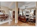 Open-concept living room with hardwood floors, fireplace, and views into the dining room at 3230 Riverhill Ct, Cumming, GA 30041