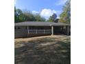 A single story home with a white picket fence, attached carport and green lawn at 2598 Miriam Ln, Decatur, GA 30032