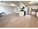 A sun-filled living room flows into an open kitchen with modern appliances and granite countertops at 3058 Arden Ridge Ter, Suwanee, GA 30024