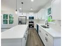 Modern kitchen with stainless appliances, quartz countertops, and ample cabinet space at 5215 Virginia Ave, Cumming, GA 30041