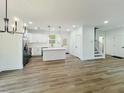 Bright, open-concept living and kitchen area with stainless appliances and modern finishes at 5215 Virginia Ave, Cumming, GA 30041