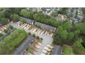 An aerial view of the neighborhood showing townhomes amongst mature trees at 5587 Strathmoor Manor Cir, Lithonia, GA 30058