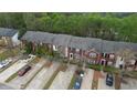 An aerial view of brick townhomes featuring multiple parking spaces at 5587 Strathmoor Manor Cir, Lithonia, GA 30058