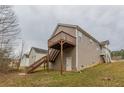 View of the house with wooden deck and a staircase at 1080 Abington Ct, Douglasville, GA 30134