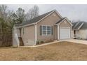 Charming home featuring a one-car garage and a well-maintained lawn at 1080 Abington Ct, Douglasville, GA 30134