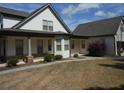 Inviting home exterior with stone pillars, a walkway, and manicured landscaping at 325 Brook Hollow Ln, Loganville, GA 30052