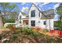 Home featuring large windows, modern style and a beautiful flowering landscape at 1430 Oconee Ne Pass, Brookhaven, GA 30319