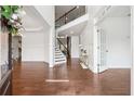 Bright foyer featuring hardwood floors, elegant staircase, and stylish decor, creating a welcoming entrance at 241 Haney Rd, Woodstock, GA 30188