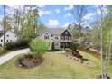 Charming home with lush front lawn, mature trees, and inviting curb appeal at 383 Indian Hills Trl, Marietta, GA 30068