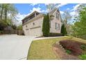 Spacious home featuring a two-car garage and a well-maintained lawn at 383 Indian Hills Trl, Marietta, GA 30068