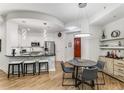 Bright kitchen with stainless steel appliances and counter seating open to a dining area at 200 River Vista Dr # 713, Atlanta, GA 30339