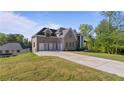 Spacious home featuring a long driveway and a large lawn at 208 Indian Hills Trail, Marietta, GA 30068