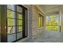 Covered porch with tile flooring and a full light front door at 208 Indian Hills Trail, Marietta, GA 30068