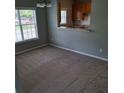 Dining area featuring large windows and neutral wall paint, with an open view to the kitchen at 8628 Thomas Rd, Riverdale, GA 30274