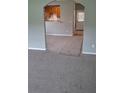 Open living room with modern paint and carpet that flows into the kitchen area at 8628 Thomas Rd, Riverdale, GA 30274