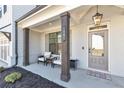 Inviting front porch showcasing elegant columns, cozy seating, and a stylish welcome area at 1501 Branthaven Ln, Auburn, GA 30011