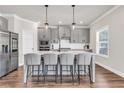 Modern kitchen featuring gray cabinets, a center island with seating, and stainless steel appliances at 1501 Branthaven Ln, Auburn, GA 30011