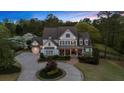 Charming home with a circular driveway, landscaped yard, and inviting front porch at 332 Chaffin Rd, Roswell, GA 30075