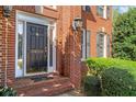Close up of a front door of a two-story brick house with a manicured lawn at 3605 Grey Abbey Dr, Alpharetta, GA 30022