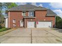 The property has a two-car garage and a spacious driveway at 3605 Grey Abbey Dr, Alpharetta, GA 30022