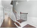 A welcoming foyer featuring hardwood floors and an elegant staircase with iron spindles at 4236 Silver Spruce Ln, Smyrna, GA 30080